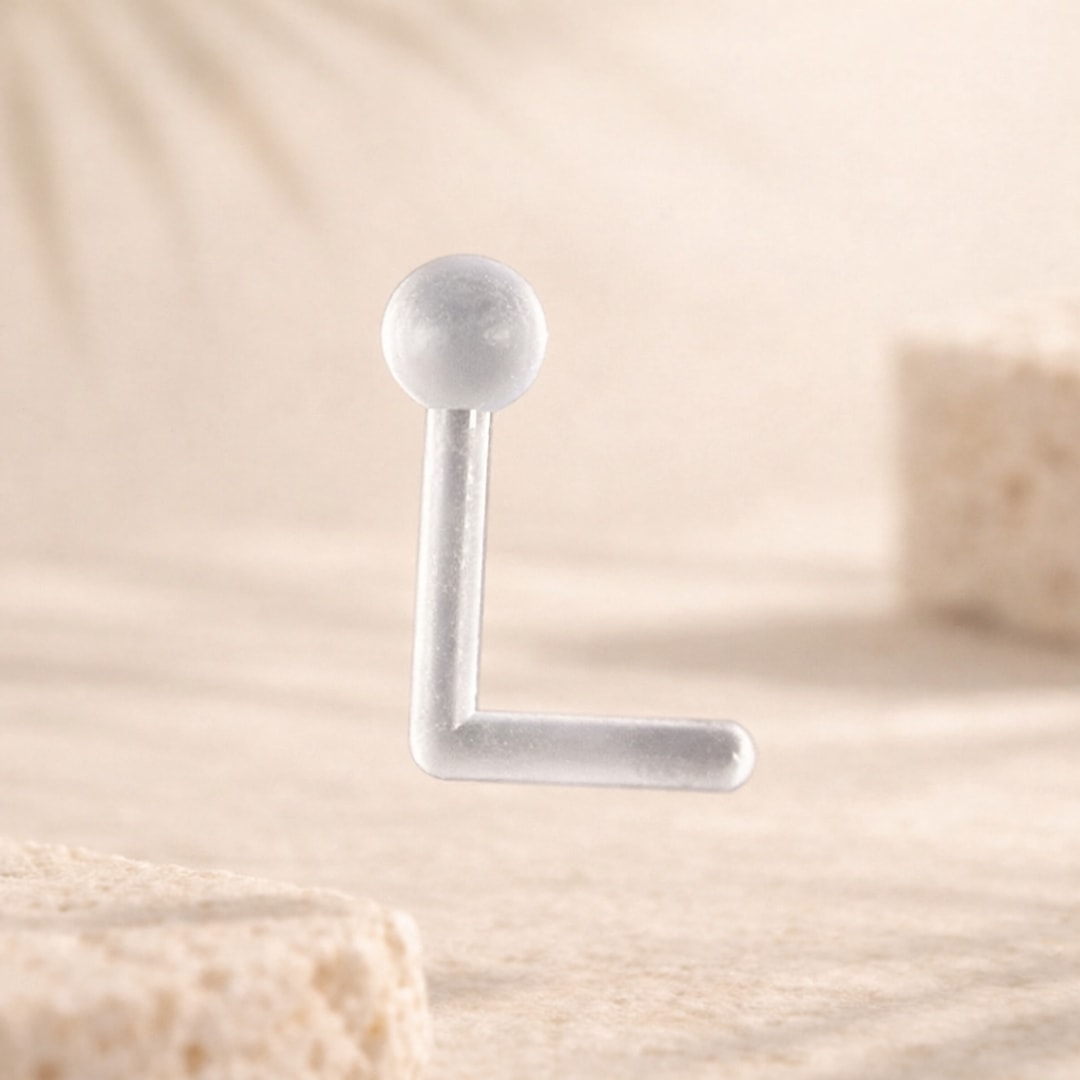 Rétainer de piercing en acrylique transparent, tige coudée en L terminée par une petite boule translucide