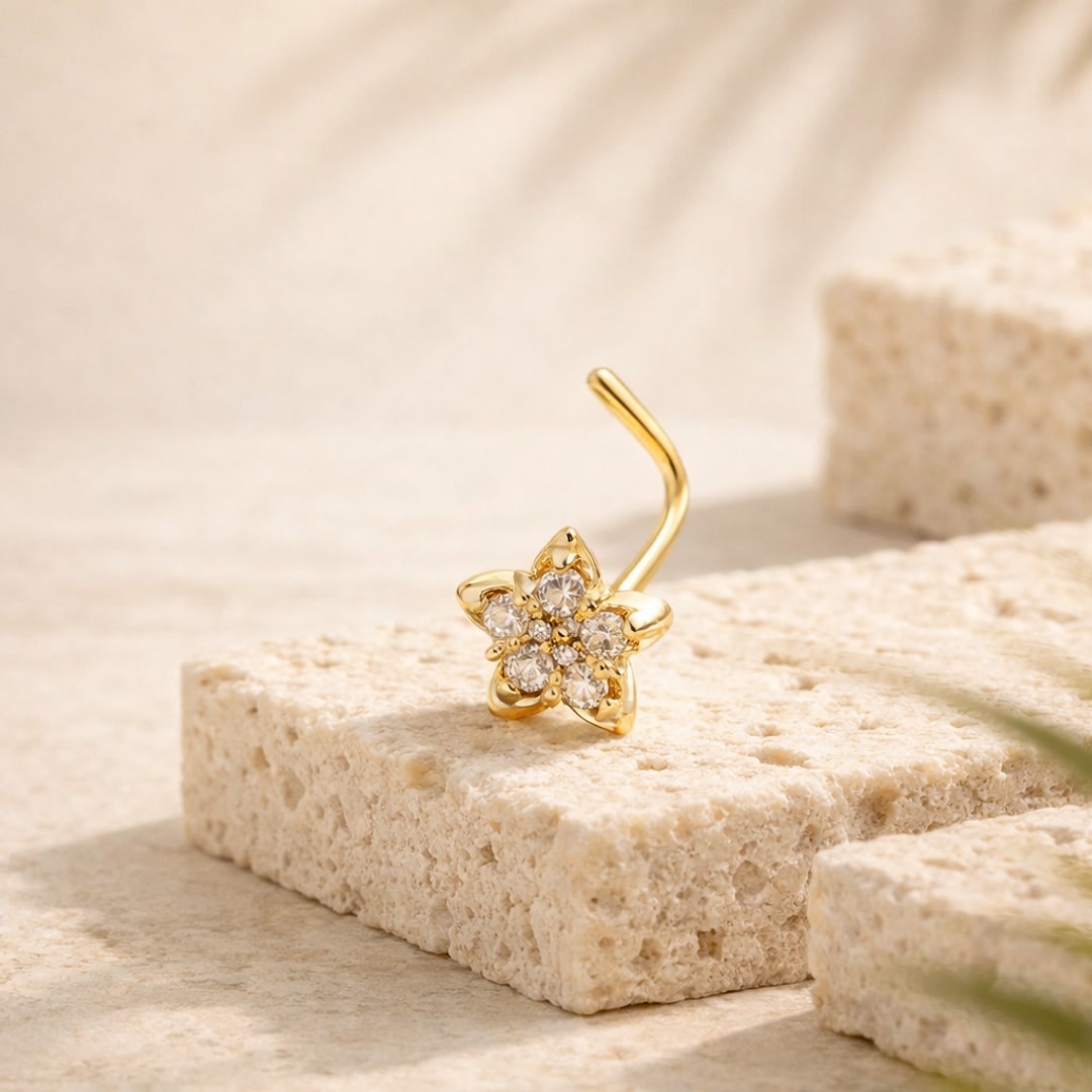 Nose stud fleur à cinq pétales sertie de zircons, tige coudée en L, posé sur une pierre claire