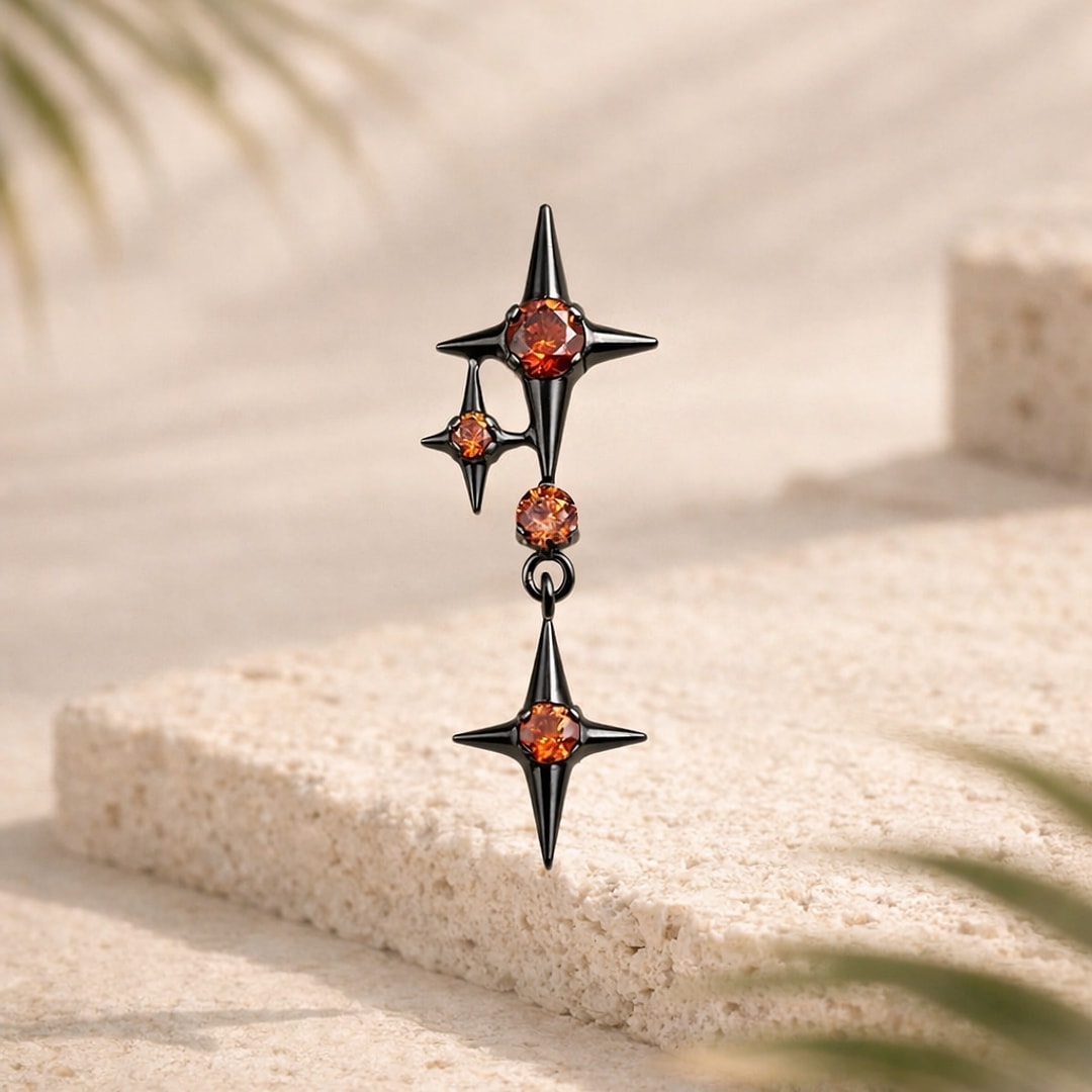 Labret en titane noir avec trois étoiles à quatre branches serties de zircons rouges, dont une pendante