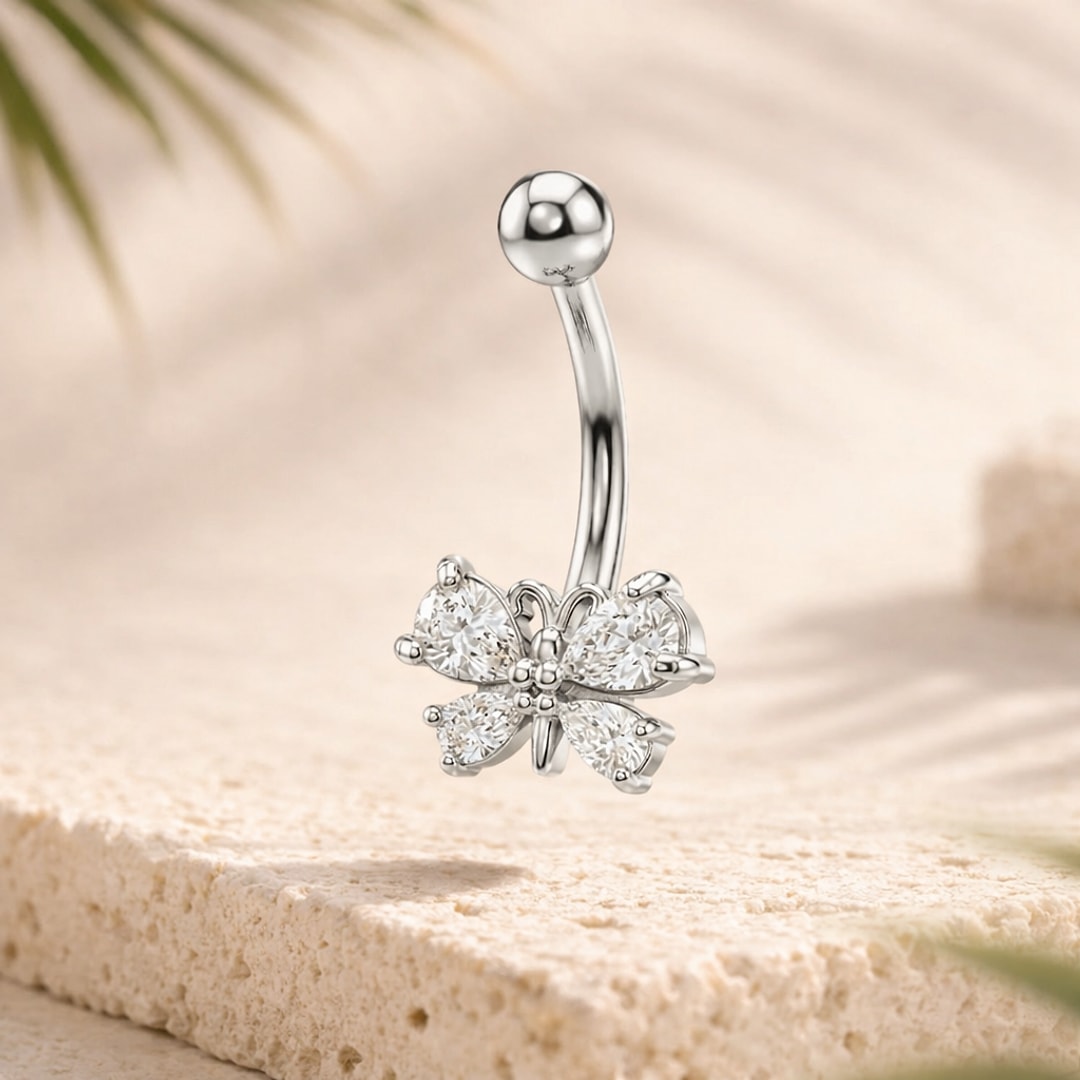 Piercing nombril acier argenté avec papillon serti de quatre pierres blanches et bille lisse en haut