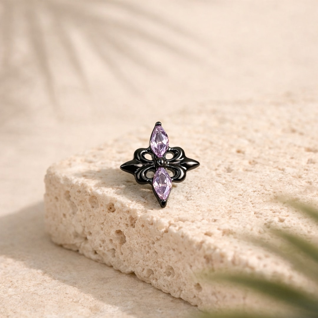 Stud flat back titane noir en forme d'étoile baroque avec deux zircons violets marquise, posé sur une pierre claire