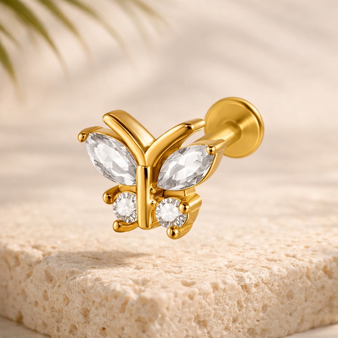 Labret papillon doré serti de pierres blanches marquise et rondes, tige acier plaqué or et disque plat