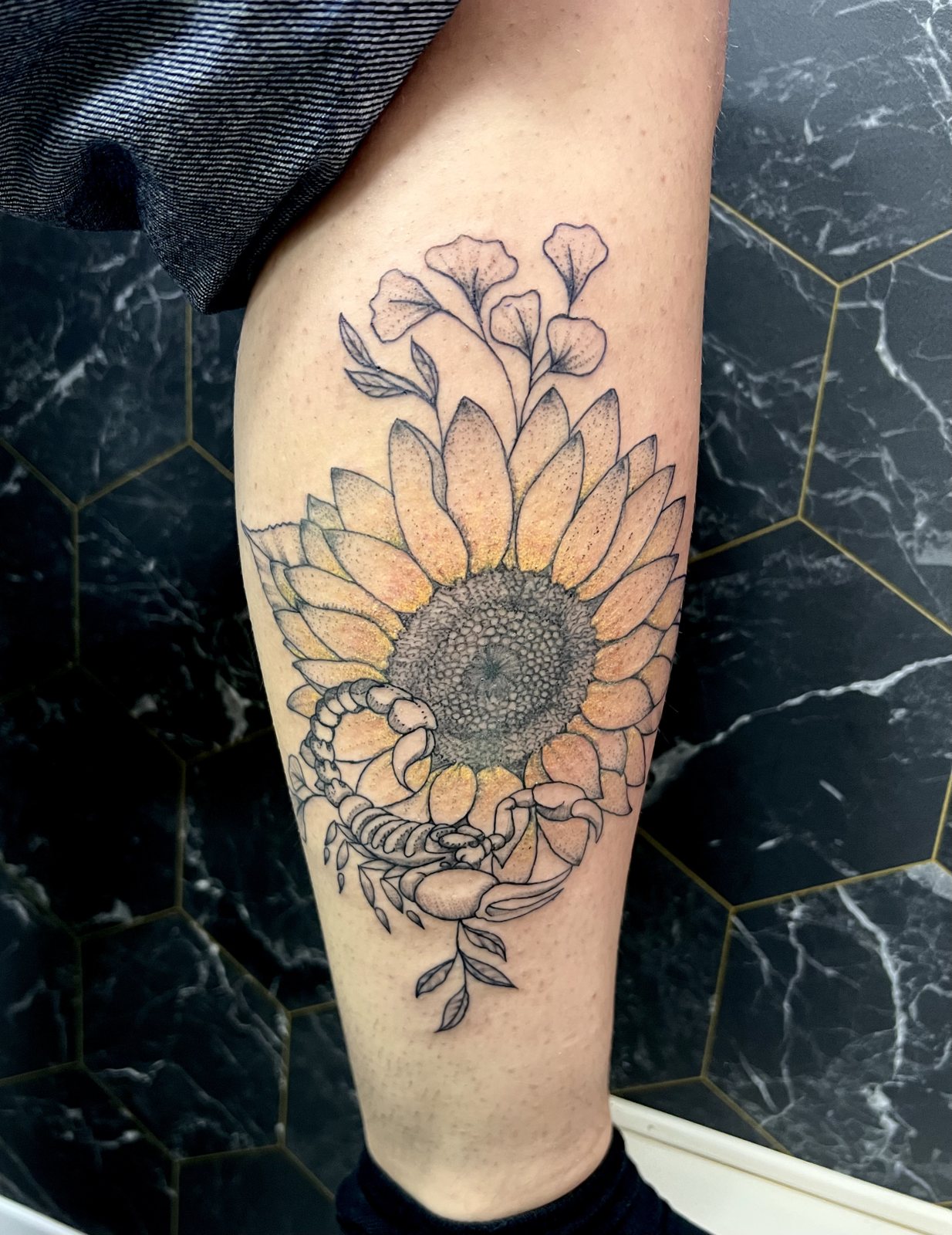 Tatouage tournesol en couleur avec des fleurs sur le mollet